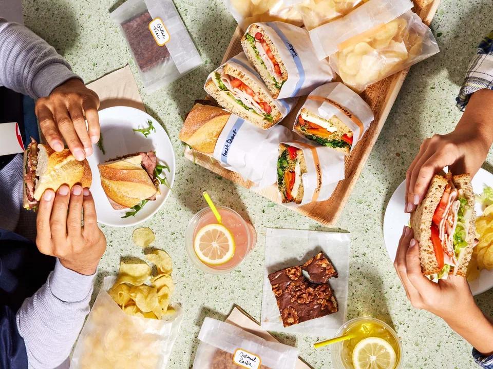 Colleagues eating lunch together around a table